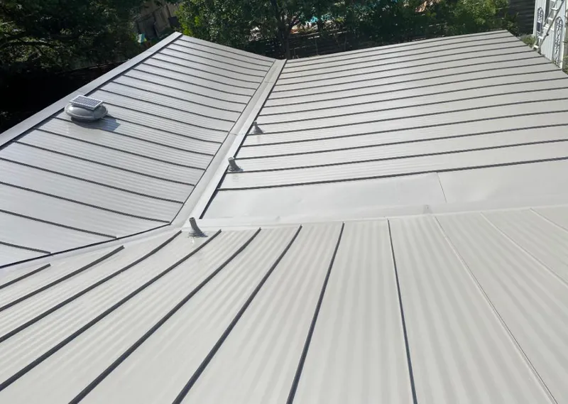 Solar attic fan installed on a metal roof for Roof Ventilation in Marlin